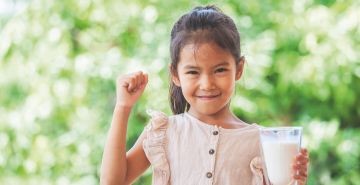 Girl holding glass of milk