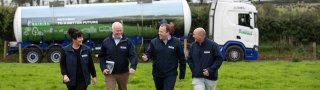 Members of the Lakeland Dairies team in front of a milk tanker.