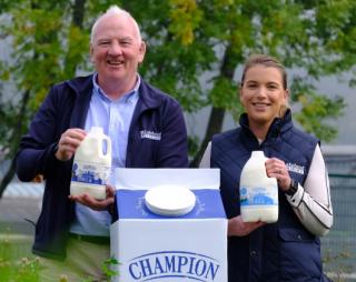Tommy O'Donaghue and Eimear Hanley holding milk cartons with tethered caps.
