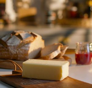 Lakeland Dairies butter on a chopping board with soda bread and jar of jam