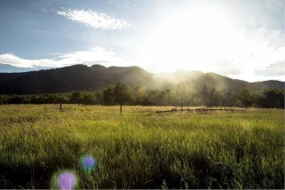 A scenic view of fields and mountains.