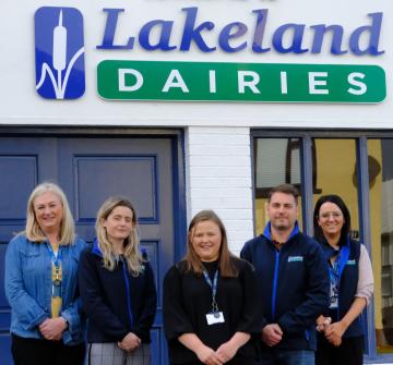 Five employees standing in front of the Lakeland Dairies Office