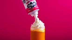 Millac Roselle aerosol can squirting cream onto a beverage