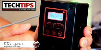 Man holding black product with red buttons