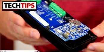 Man holding inside of product with blue and green circuit board