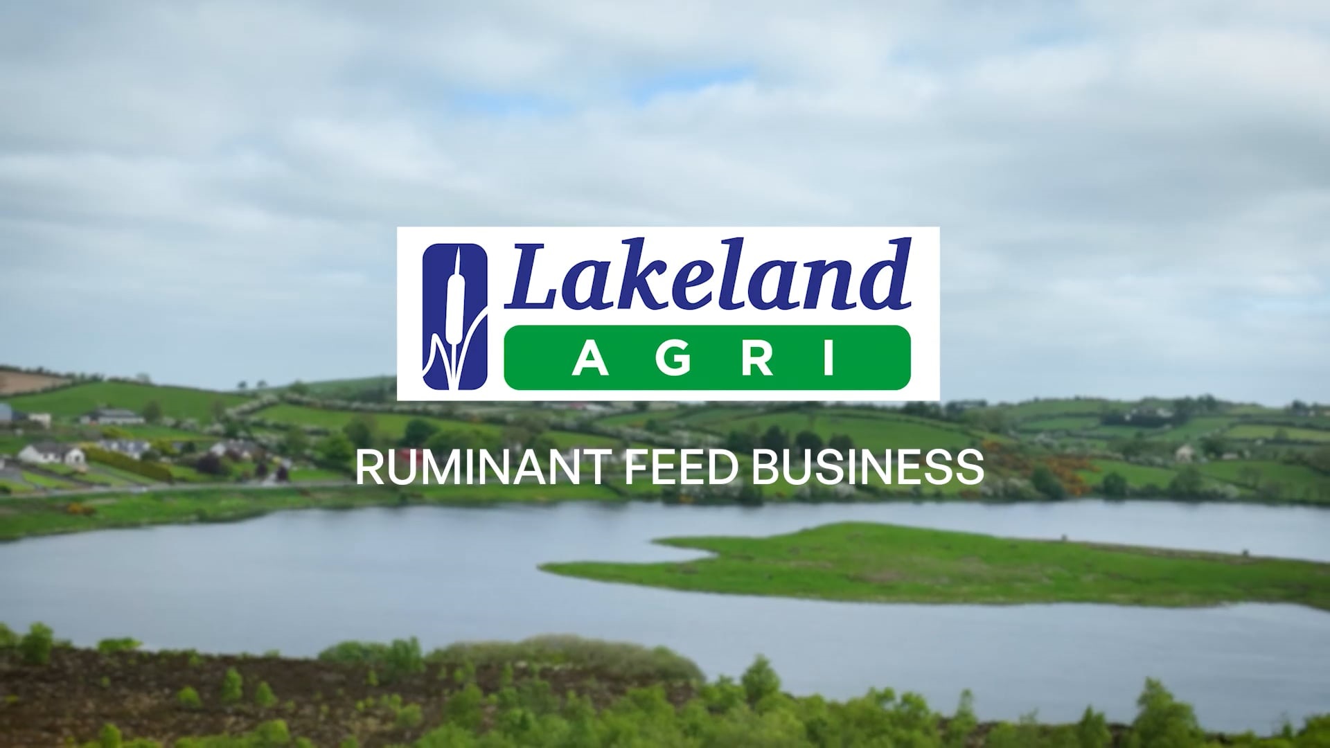 Cover for the Lakeland Dairies ruminant feed video. A lake surrounded by hills.