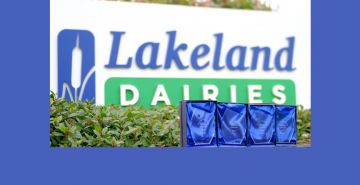 Lakeland Dairies awards in front of logo sign outside of HQ building
