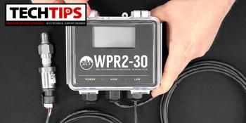 Man holding black thermostat product with cable